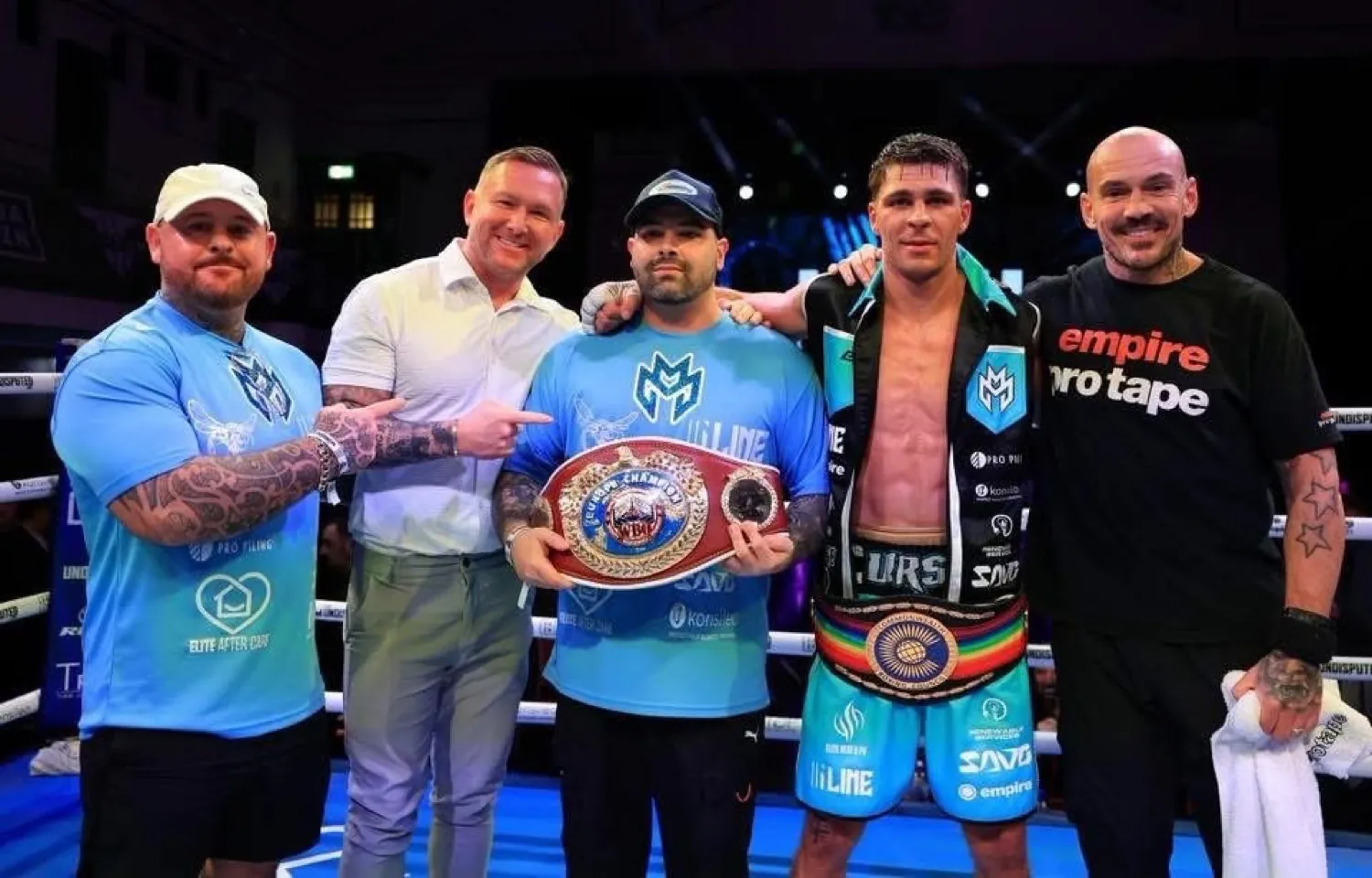 Constantin Ursu wearing the Commonwealth belt beside a team member holding the WBO European belt